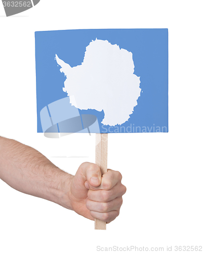 Image of Hand holding small card - Flag of Antarctica