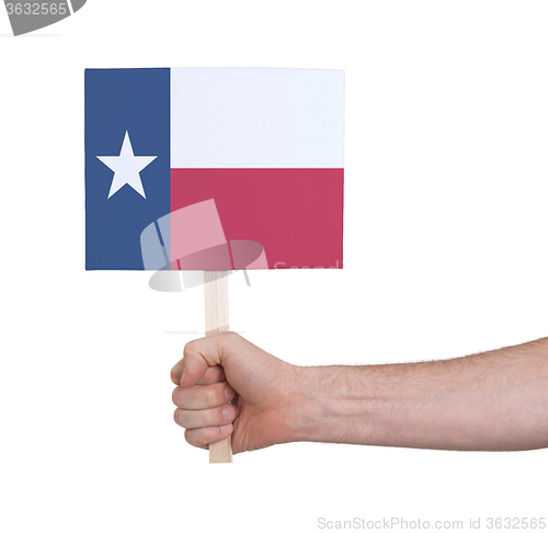 Image of Hand holding small card - Flag of Texas