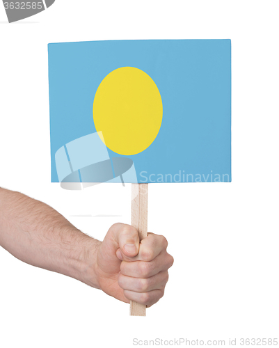 Image of Hand holding small card - Flag of Palau