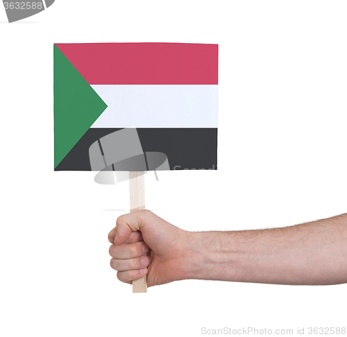 Image of Hand holding small card - Flag of Sudan