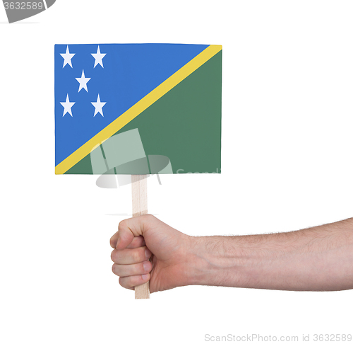 Image of Hand holding small card - Flag of Solomon Islands