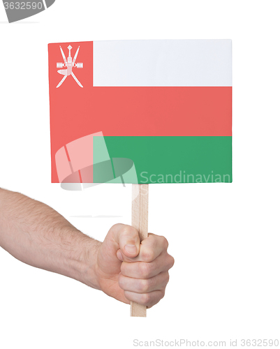 Image of Hand holding small card - Flag of Oman