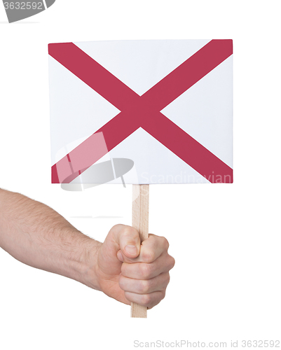 Image of Hand holding small card - Flag of Alabama