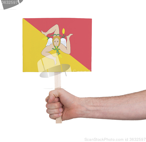 Image of Hand holding small card - Flag of Sicily