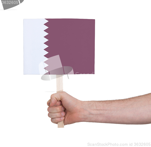 Image of Hand holding small card - Flag of Qatar