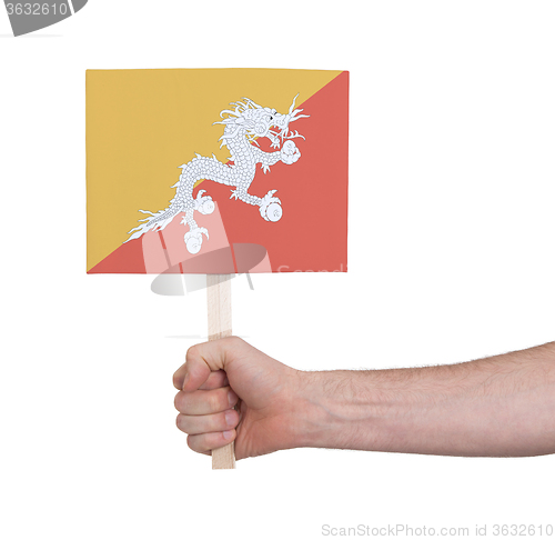 Image of Hand holding small card - Flag of Bhutan