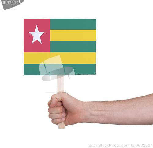 Image of Hand holding small card - Flag of Togo