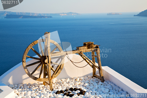 Image of greece in santorini  sea and spinning wheel