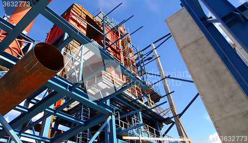 Image of cranes and beams on construction of industrial factory 