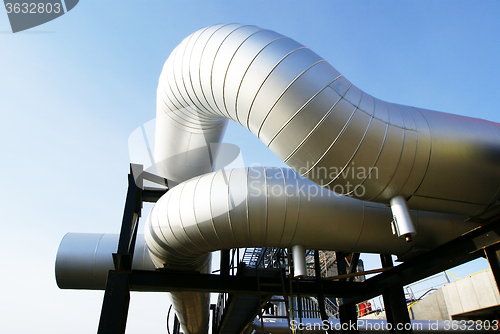 Image of Industrial zone, Steel pipelines and valves against blue sky