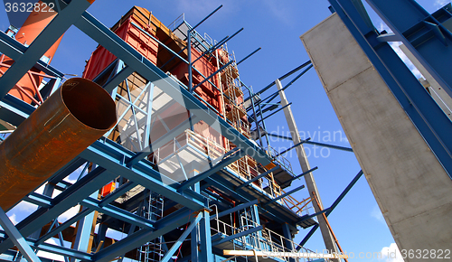 Image of cranes and beams on construction of industrial factory 