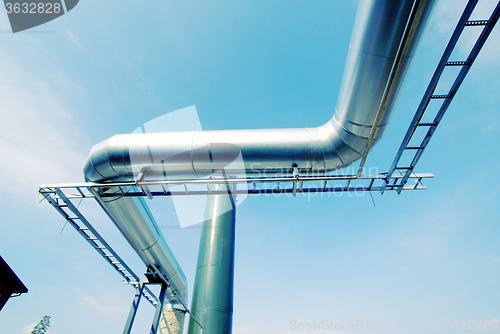 Image of Industrial zone, Steel pipe-lines on blue sky