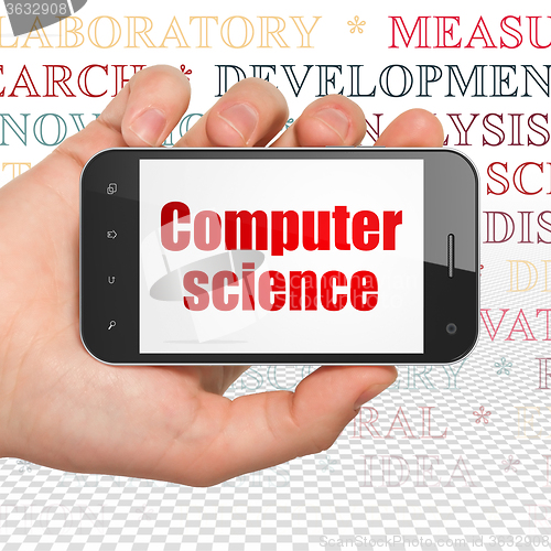 Image of Science concept: Hand Holding Smartphone with Computer Science o