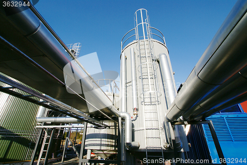 Image of Industrial zone, Steel pipelines and valves against blue sky