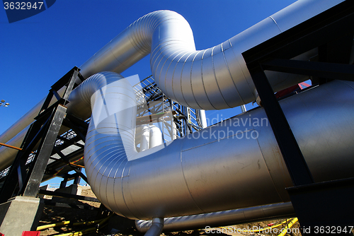 Image of Industrial zone, Steel pipelines and valves against blue sky