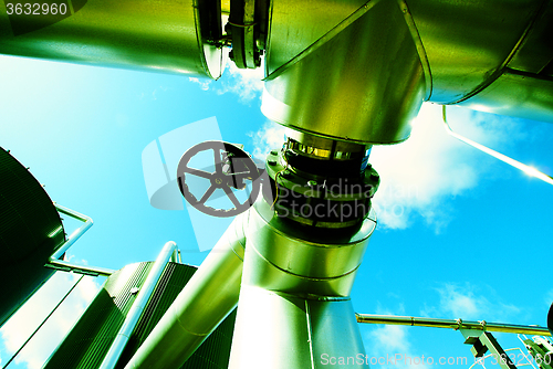 Image of Industrial zone, Steel pipelines and valves against blue sky