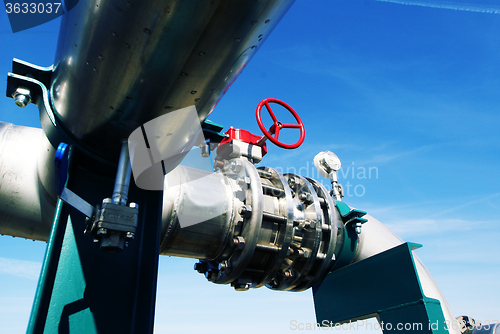 Image of Industrial zone, Steel pipelines and valves against blue sky