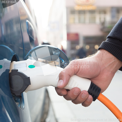 Image of Electric Car in Charging Station.