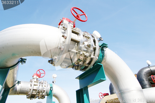 Image of Industrial zone, Steel pipelines and valves against blue sky