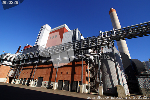 Image of Modern industrial factory against blue sky