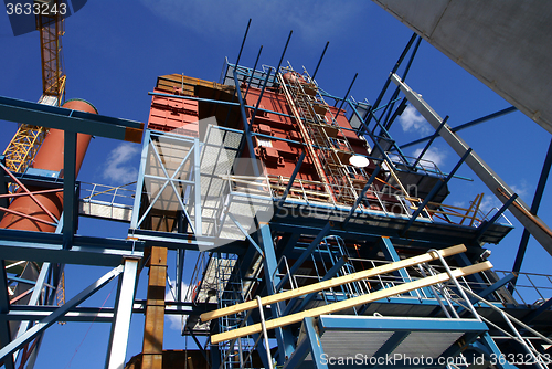 Image of cranes and beams on construction of industrial factory 