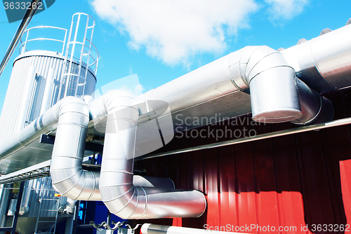 Image of Industrial zone, Steel pipelines and valves against blue sky