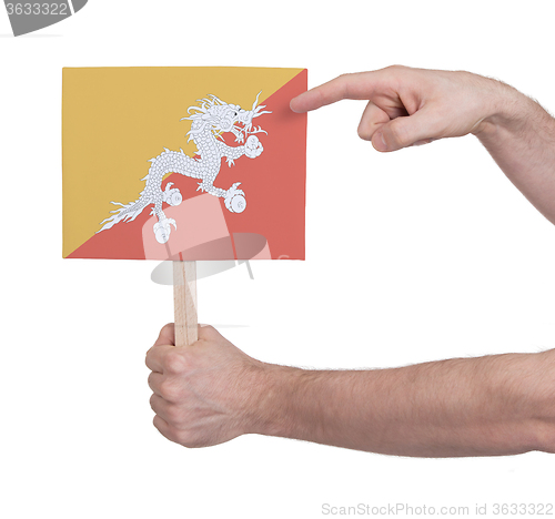 Image of Hand holding small card - Flag of Bhutan