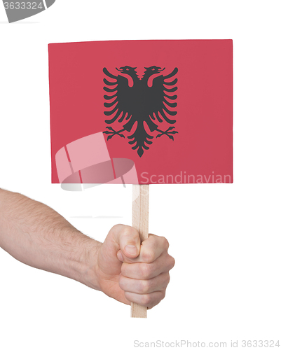 Image of Hand holding small card - Flag of Albania