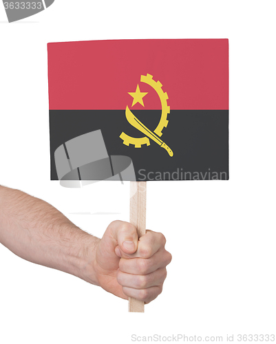 Image of Hand holding small card - Flag of Angola