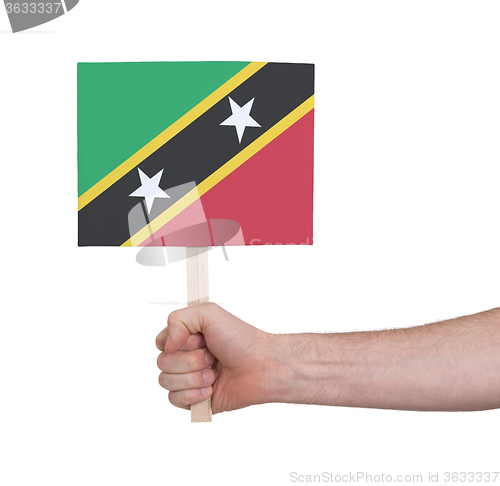 Image of Hand holding small card - Flag of Saint Kitts and Nevis