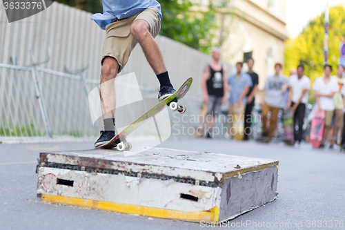 Image of Boys skateboarding on street. Urban life.