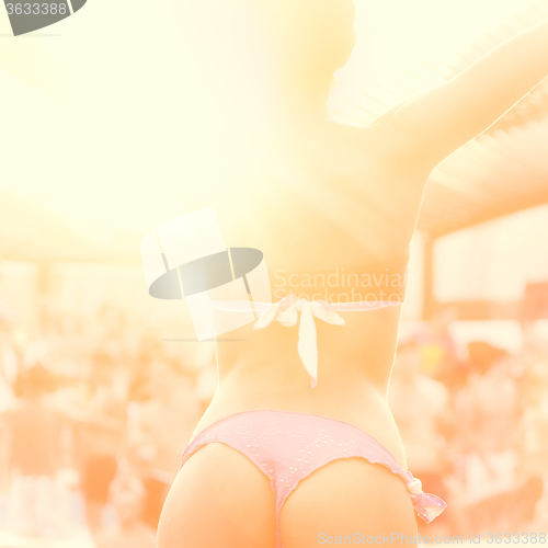 Image of Sexy girl dancing on a beach party.