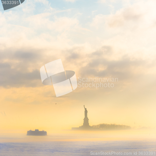 Image of Staten Island Ferry cruises past the Statue of Liberty.