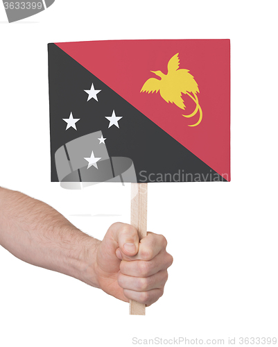 Image of Hand holding small card - Flag of Papua New Guinea