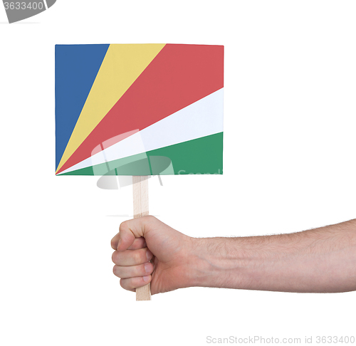 Image of Hand holding small card - Flag of Seychelles