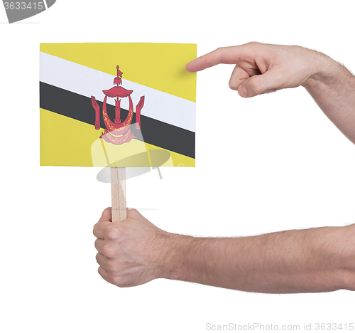 Image of Hand holding small card - Flag of Brunei