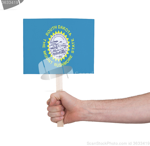 Image of Hand holding small card - Flag of South Dakota