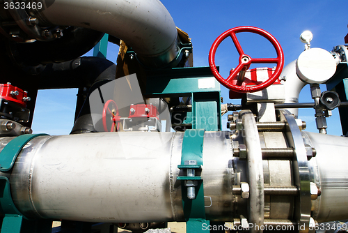 Image of Industrial zone, Steel pipelines and valves against blue sky