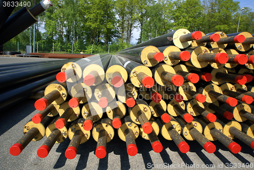 Image of PVC pipes stacked in construction site    