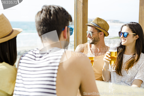 Image of Friends drinking a cold beer