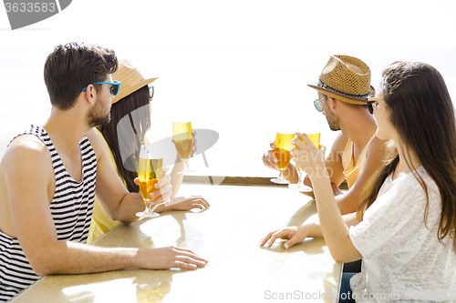 Image of Friends drinking a cold beer