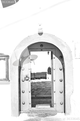 Image of white  red brown  door in antique village santorini greece europ