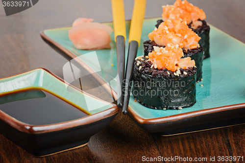 Image of Sushi rolls served on blue plate