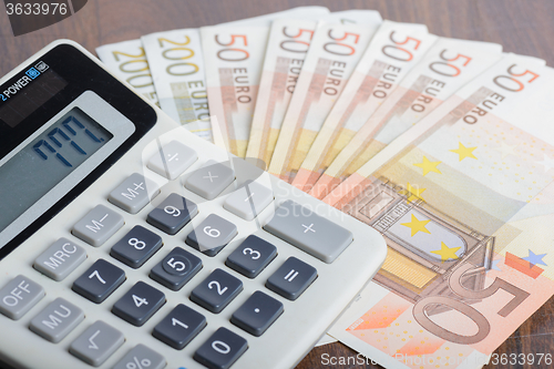 Image of Calculator and banknotes on the table