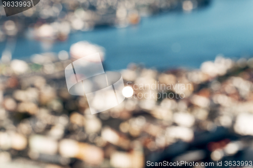 Image of Defocused view of Bergen city with sun reflection in window