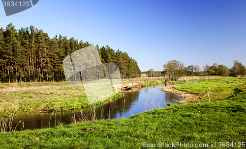 Image of narrow river in the field  