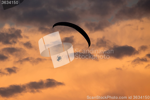 Image of unidentified skydiver, parachutist on dramatic sky