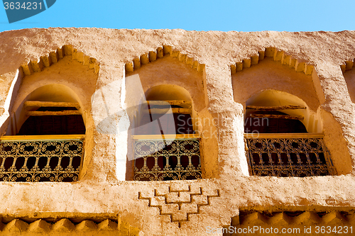 Image of   yellow window in   construction and brown wall  