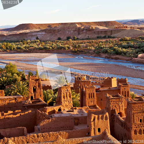 Image of sunset in africa old construction near the river blue