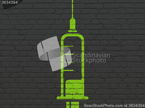 Image of Medicine concept: Syringe on wall background